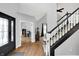 Gracious foyer with hardwood floors, staircase, and a view into the living spaces at 8819 Anchor Bay Ct, Indianapolis, IN 46236