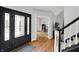 Elegant foyer with hardwood flooring, decorative front door, and open floor plan at 8819 Anchor Bay Ct, Indianapolis, IN 46236