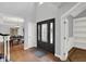 Open foyer area with hardwood floors, transom windows, and views of the dining room at 8819 Anchor Bay Ct, Indianapolis, IN 46236