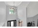 Bright foyer with high ceilings, a stylish chandelier, and an arched window above the front door at 8819 Anchor Bay Ct, Indianapolis, IN 46236