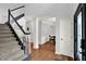 Inviting foyer with hardwood floors, staircase, and view into the dining room at 8819 Anchor Bay Ct, Indianapolis, IN 46236