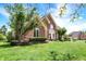 Brick home featuring a well-manicured lawn and mature landscaping in a suburban setting at 8819 Anchor Bay Ct, Indianapolis, IN 46236