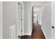 Hallway with wood floors and white trim provides access to multiple rooms within the house at 8819 Anchor Bay Ct, Indianapolis, IN 46236