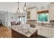 Beautiful kitchen with granite countertops, white cabinets, a kitchen island, and stainless steel appliances at 8819 Anchor Bay Ct, Indianapolis, IN 46236