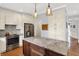 Well-equipped kitchen boasting stainless steel appliances, white cabinets, granite countertops, and a kitchen island at 8819 Anchor Bay Ct, Indianapolis, IN 46236
