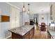Spacious kitchen featuring a granite-topped island, stainless appliances, white cabinetry, and an open layout at 8819 Anchor Bay Ct, Indianapolis, IN 46236