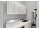 Well-lit laundry room features a washer and dryer plus lots of storage space above at 8819 Anchor Bay Ct, Indianapolis, IN 46236