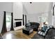 Open-concept living room with a fireplace, vaulted ceilings and stylish furniture at 8819 Anchor Bay Ct, Indianapolis, IN 46236