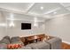 Finished basement with recessed lighting, large tv, comfortable gray sectional sofa, and wood floors at 8819 Anchor Bay Ct, Indianapolis, IN 46236