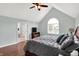 Comfortable main bedroom with vaulted ceiling, ceiling fan, hardwood floors, and ensuite bathroom at 8819 Anchor Bay Ct, Indianapolis, IN 46236