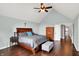 Comfortable main bedroom with vaulted ceiling, ceiling fan, hardwood floors, and ample closet space at 8819 Anchor Bay Ct, Indianapolis, IN 46236