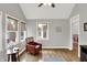 Cozy sitting room featuring hardwood floors, a vaulted ceiling, and comfortable seating arrangement by the windows at 8819 Anchor Bay Ct, Indianapolis, IN 46236