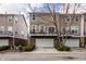 A row of townhomes, each with garage, driveway, balcony, and neat landscaping at 958 Rosalind Pl, Carmel, IN 46032