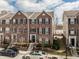 Classic brick townhome with neat landscaping, black shutters, and inviting entryway steps at 958 Rosalind Pl, Carmel, IN 46032