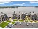 Aerial view of lakeside condos showcasing ample parking, manicured lawns, and lake views at 102 Clarendon Dr # 409, Noblesville, IN 46062