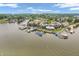 Stunning aerial view of lakeside condos with docks, lush green landscaping, and community amenities at 102 Clarendon Dr # 409, Noblesville, IN 46062