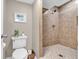 Bathroom featuring a tiled shower stall, toilet, and neutral tones at 102 Clarendon Dr # 409, Noblesville, IN 46062