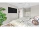 Bedroom with a television, palm-themed bedding, and a leafy green plant at 102 Clarendon Dr # 409, Noblesville, IN 46062