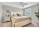 Bedroom showcasing a queen-sized bed, a ceiling fan, and a view from the window at 102 Clarendon Dr # 409, Noblesville, IN 46062