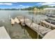 Dock with boat and jet ski lifts, offering easy access to water activities from this lakeside property at 102 Clarendon Dr # 409, Noblesville, IN 46062