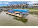 Aerial view of boat docks highlighting lake access and community amenities with condo complex in the background at 102 Clarendon Dr # 409, Noblesville, IN 46062