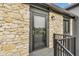 Condo entrance showcasing stone detail, black trim, modern lighting, and a black metal stair railing at 102 Clarendon Dr # 409, Noblesville, IN 46062