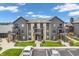 Exterior of modern condos showing stone accents and parking, surrounded by green landscaping at 102 Clarendon Dr # 409, Noblesville, IN 46062