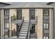 Close-up of a condo entrance featuring stone facade, private balcony, and modern exterior lighting at 102 Clarendon Dr # 409, Noblesville, IN 46062