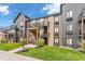 Exterior of condo featuring stone accents, private balconies, and lush landscaped grounds at 102 Clarendon Dr # 409, Noblesville, IN 46062