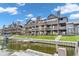 Condominium exterior featuring private balconies, lush green lawns, and docks with easy lake access at 102 Clarendon Dr # 409, Noblesville, IN 46062