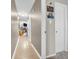 Hallway featuring a tiled floor, neutral paint, and a view of the living room with stone fireplace at 102 Clarendon Dr # 409, Noblesville, IN 46062
