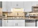 Well-lit kitchen with stainless steel appliances, ample cabinet space, and neutral countertops at 102 Clarendon Dr # 409, Noblesville, IN 46062