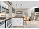 Kitchenette with stainless steel appliances, pendant lighting, and breakfast bar seating at 102 Clarendon Dr # 409, Noblesville, IN 46062