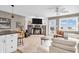 Open living space featuring a stone fireplace, white couch, and access to a small kitchen area at 102 Clarendon Dr # 409, Noblesville, IN 46062