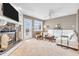 Inviting living room with stone fireplace, white sofa, ceiling fan, and natural light at 102 Clarendon Dr # 409, Noblesville, IN 46062