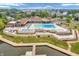 Aerial view of resort-style pool with lounging areas and waterfront access at 102 Clarendon Dr # 409, Noblesville, IN 46062