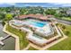 Aerial shot of a community pool with lounge chairs and amenities by the lake at 102 Clarendon Dr # 409, Noblesville, IN 46062