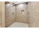 Elegant tiled shower features dual shower heads and convenient built-in shelving for a spa-like experience at 102 Clarendon Dr # 409, Noblesville, IN 46062