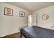 Another bedroom with a bed, modern art and a round mirror. The doorway leads to another space at 1433 E Fletcher Ave, Indianapolis, IN 46203