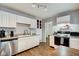 Well-lit kitchen with stainless steel appliances, white cabinetry, and a connecting dining space at 1433 E Fletcher Ave, Indianapolis, IN 46203