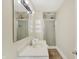Bright bathroom featuring a shower with glass doors and modern fixtures at 1901 N Tillotson Ave, Muncie, IN 47304