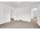 Bright bedroom with neutral carpet, white walls, and multiple doorways at 1901 N Tillotson Ave, Muncie, IN 47304