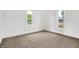 Bright bedroom featuring plush carpeting, neutral paint, and two windows offering natural light at 1901 N Tillotson Ave, Muncie, IN 47304