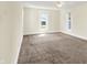 Spacious bedroom with neutral walls, two windows, and carpet at 1901 N Tillotson Ave, Muncie, IN 47304