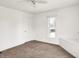 A bedroom with neutral carpet, white trim, and a ceiling fan at 1901 N Tillotson Ave, Muncie, IN 47304