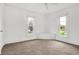 Bright bedroom with neutral carpet, white walls, corner nook, and natural light from two windows at 1901 N Tillotson Ave, Muncie, IN 47304