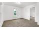 Bright bedroom with neutral carpet, white walls, and a sliding closet door at 1901 N Tillotson Ave, Muncie, IN 47304