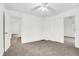 Spacious bedroom features neutral carpet, white walls, and a ceiling fan at 1901 N Tillotson Ave, Muncie, IN 47304