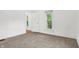 Bright bedroom with neutral carpet, white walls, and natural light from two windows at 1901 N Tillotson Ave, Muncie, IN 47304
