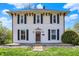Charming two-story home with black shutters and a well-manicured lawn at 1901 N Tillotson Ave, Muncie, IN 47304